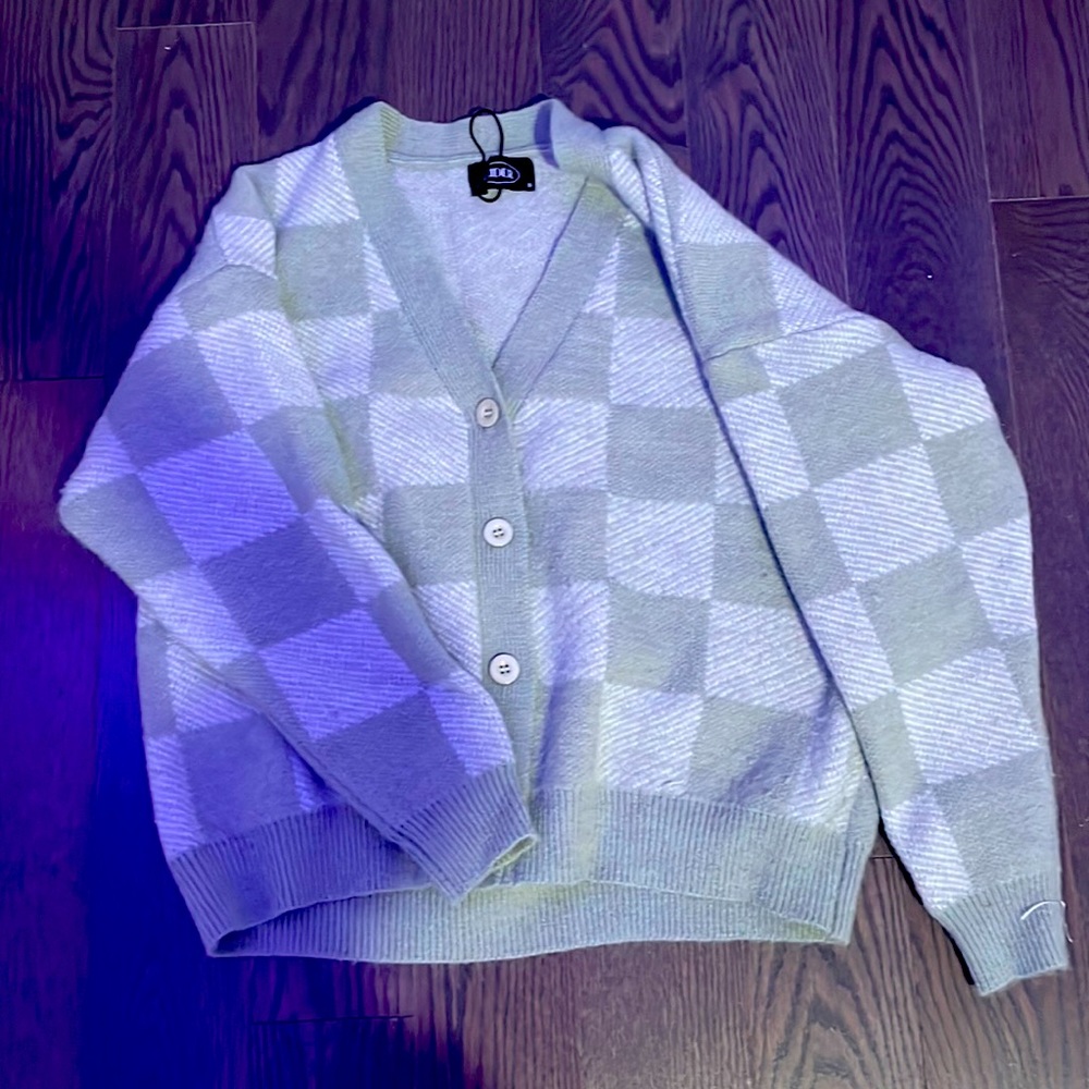 This cardigan is from cider the small business. Its pastel green with some gray.